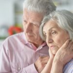 Concerned elderly couple looking off into the distance