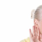 Woman with her hand to her ear