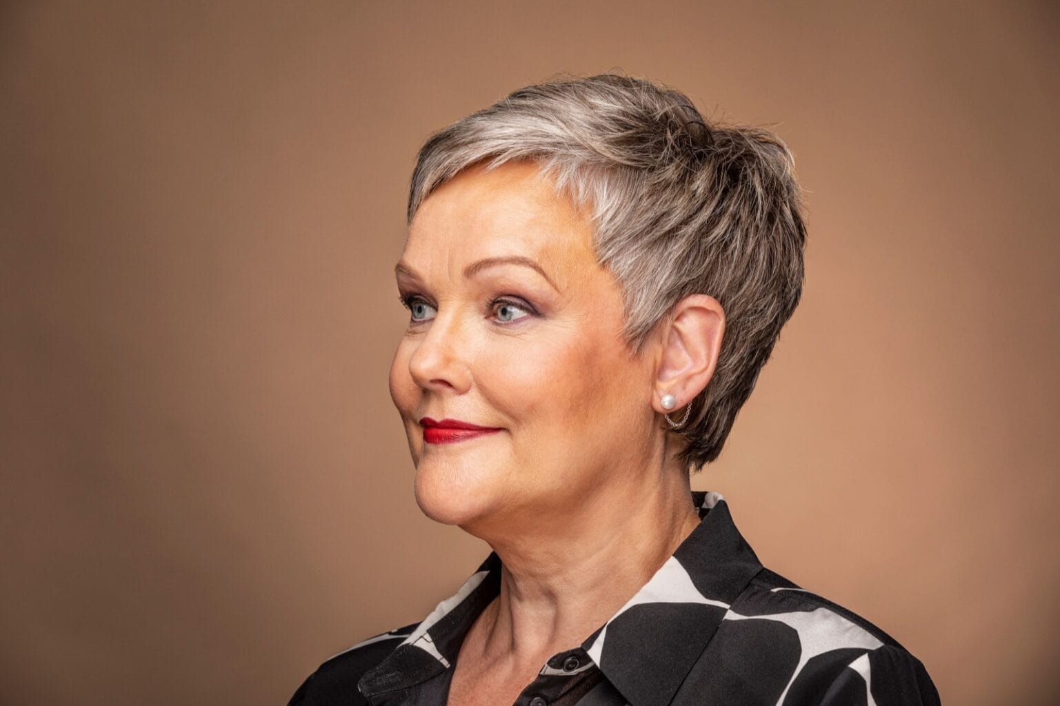 Hearing aid jewelry on older woman